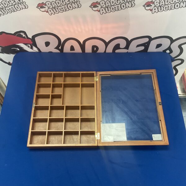 Vintage wooden display case with glass front and grid compartments.
