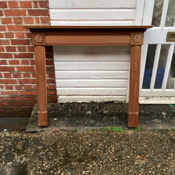 Vintage wooden mantlepiece with turned legs and a classic design.