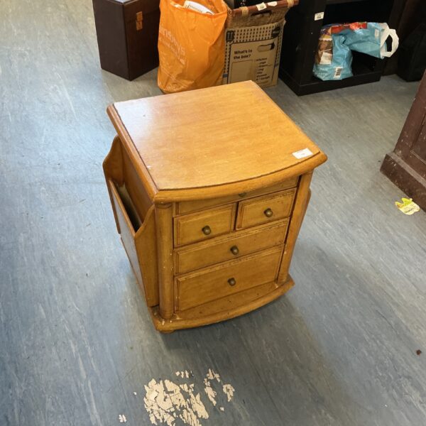 Vintage wooden side table with magazine rack storage.