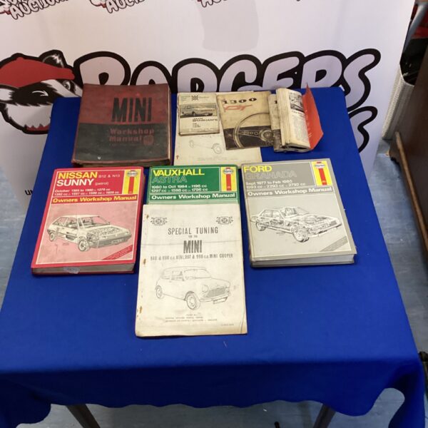 Collection of vintage workshop manuals for Ford, Vauxhall and Nissan cars.
