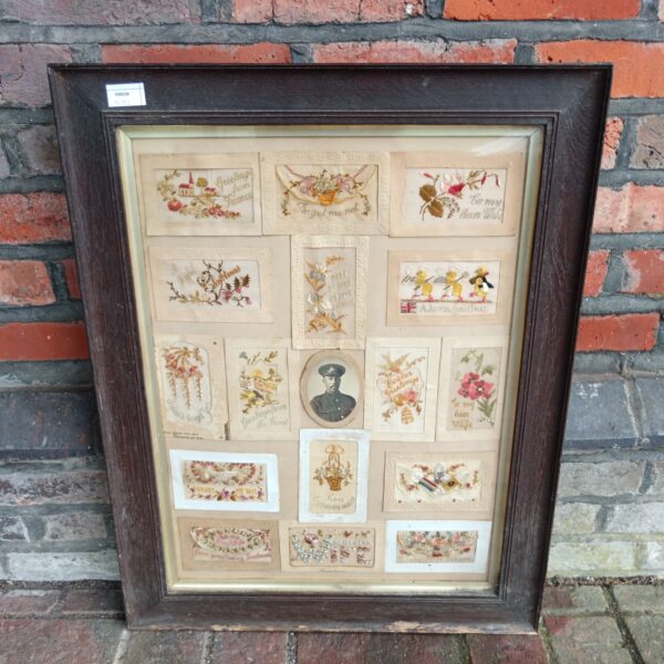 Framed collection of WWI silk embroidered sweetheart postcards.