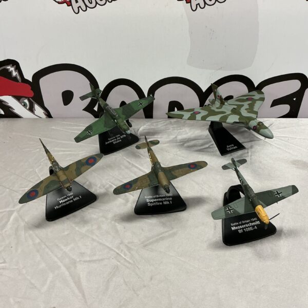 WWII diecast aircraft lot featuring Spitfire and Hurricane models.