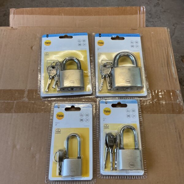 Set of four Yale padlocks in original packaging for security.