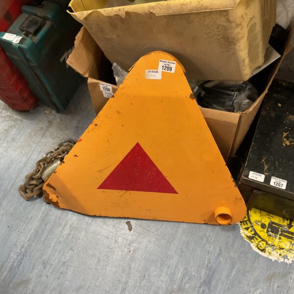 Yellow triangular wheel clamp for vehicle security.