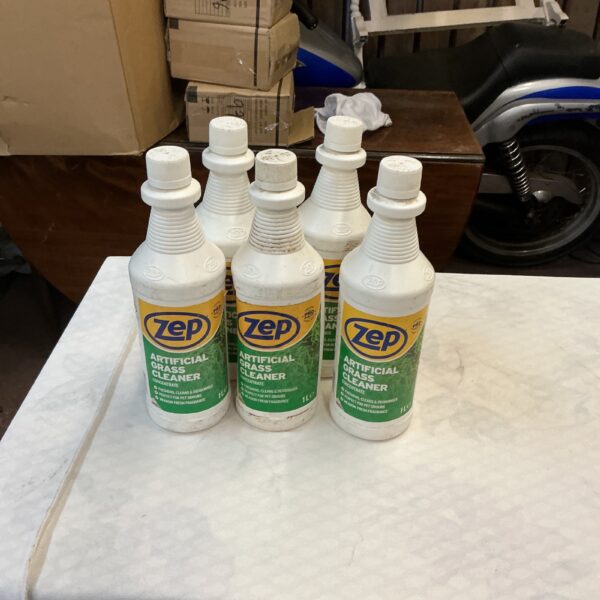 Five bottles of Zep Artificial Grass Cleaner for outdoor turf.