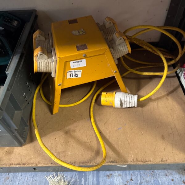 Yellow four-gang 110v extension lead for site use.