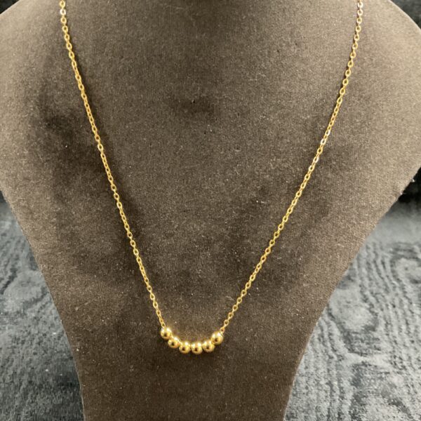 Elegant 18ct gold plated bead necklace on a neutral background.