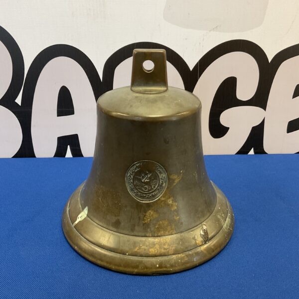 Antique 19th-century bronze signalling bell with raised emblem.