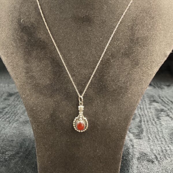 Close-up of 925 silver amber pendant necklace with warm tones.