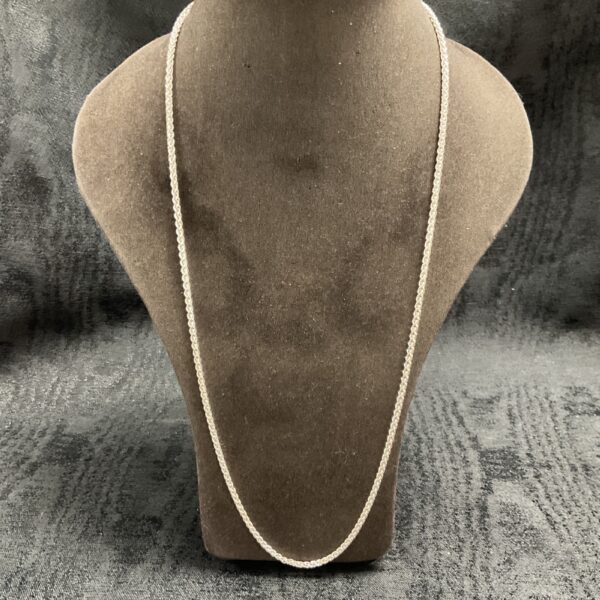 Close-up of a 925 silver rope chain necklace on a display stand.