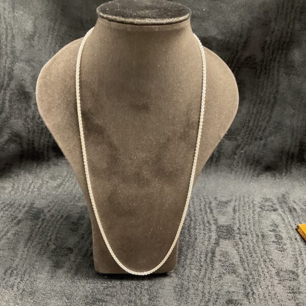 Close-up of a 925 silver rope chain necklace on a display stand.