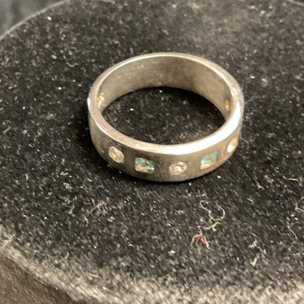Silver ring with white stones and topaz gemstone.