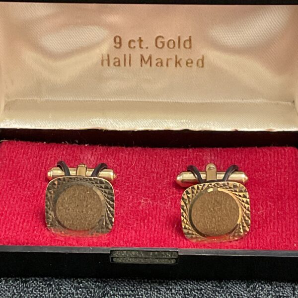 Pair of 9ct gold square cufflinks on a red display.