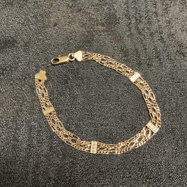 Vintage 9ct gold triple chain bracelet, detailed close-up.