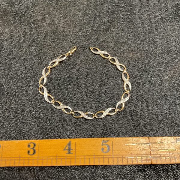Elegant 9ct gold two-tone bracelet with linked design.