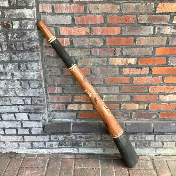 Large Aboriginal didgeridoo with traditional ochre artwork.