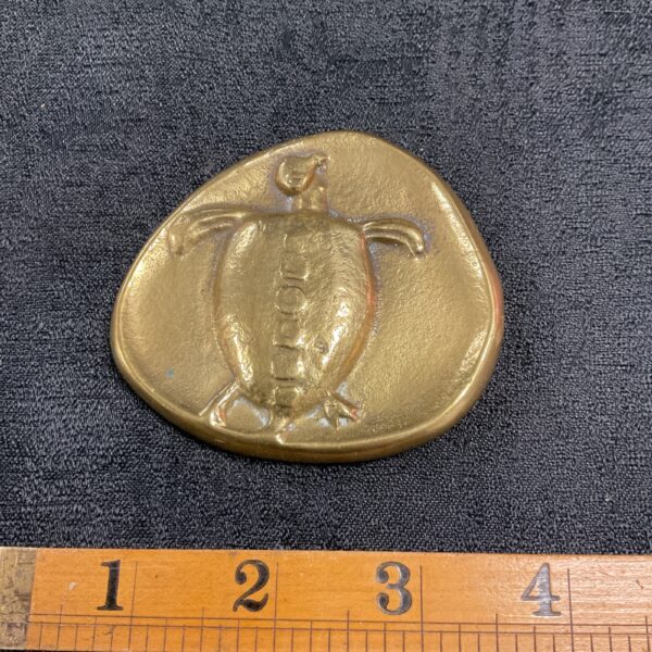 Front view of the Aegina Turtle coin reproduction, a detailed replica.