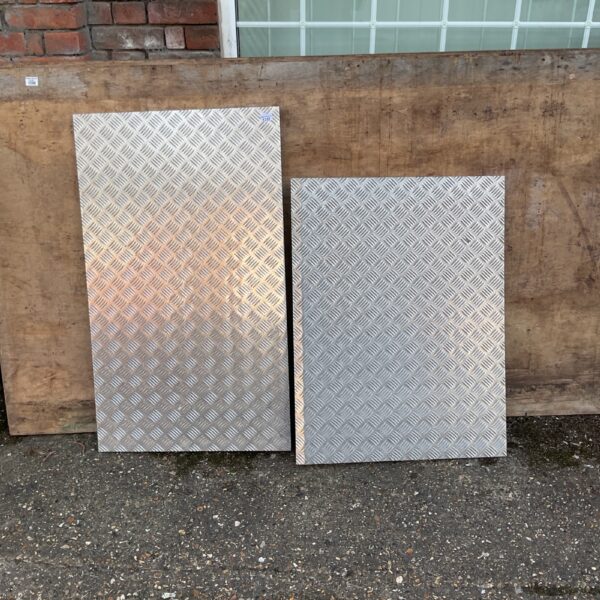 Pair of aluminium car ramps for vehicle maintenance.