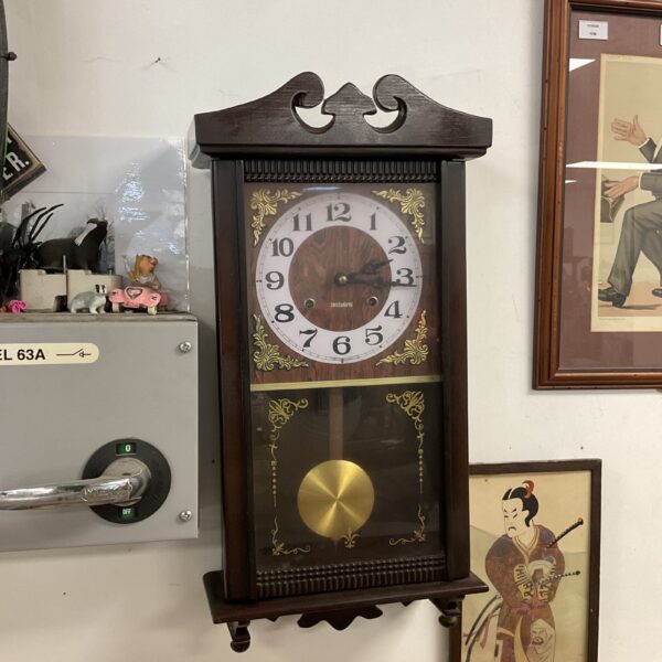 Antique 30-day wall clock with pendulum and roman numerals.