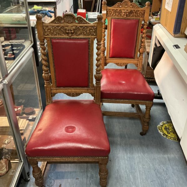 Pair of antique Baroque dining chairs with red upholstery.