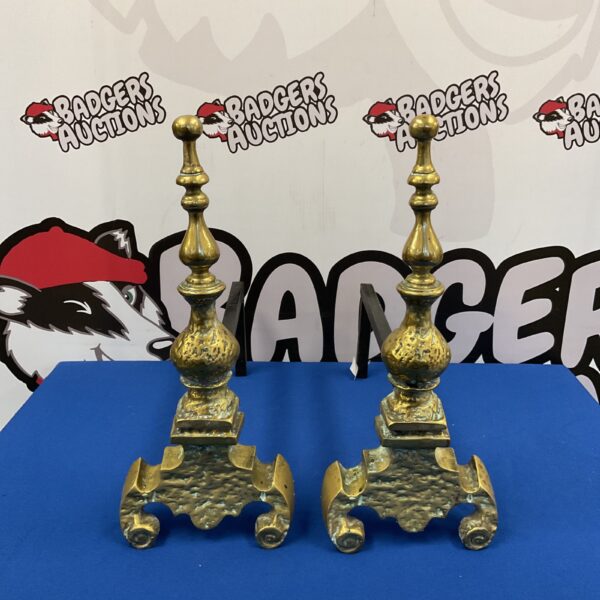Ornate antique brass fire dogs for a classic fireplace.