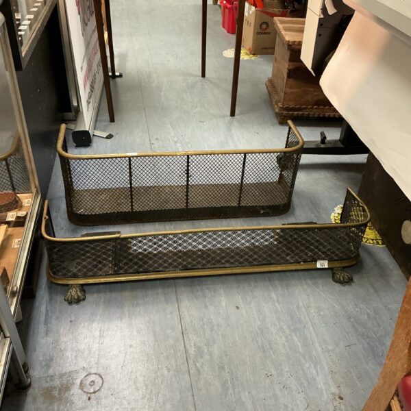 Antique brass fire guard with woven mesh panel.