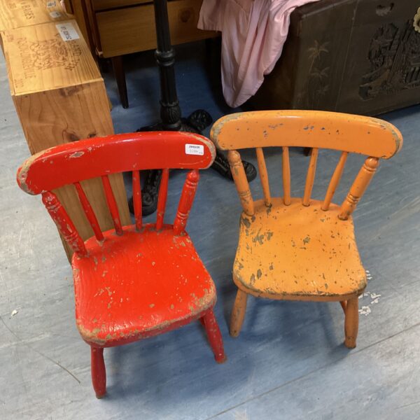Pair of antique children’s stick back chairs with distressed paint.