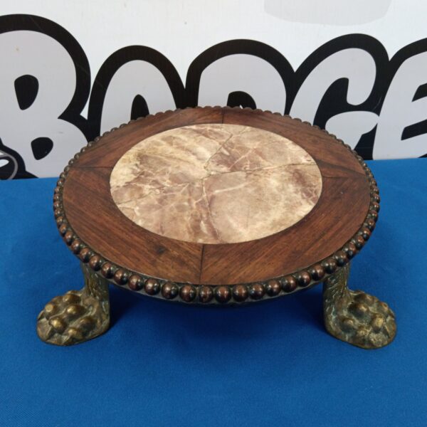 Antique claw footed trivet with marble top and iron feet.