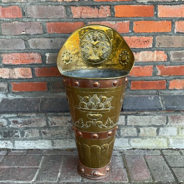 Antique copper stick stand with fleur de lis and knight engraving.