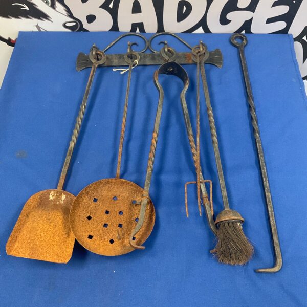 Antique wrought iron fireplace companion set with shovel, poker, tongs, and brush.