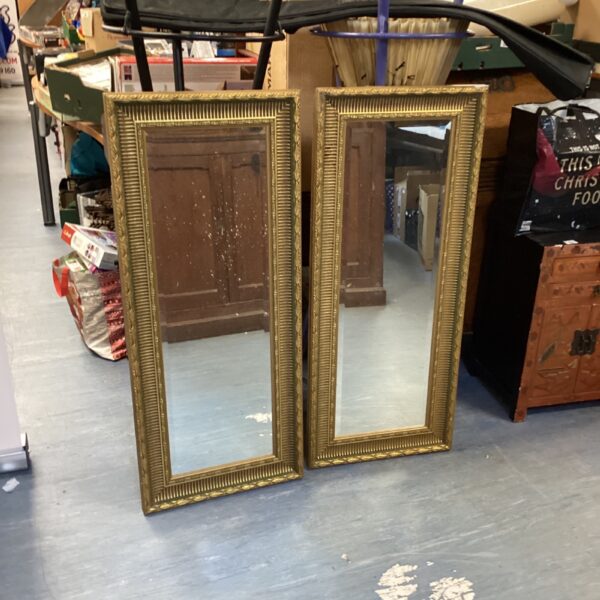 Ornate gilt framed mirrors, antique wall decor.