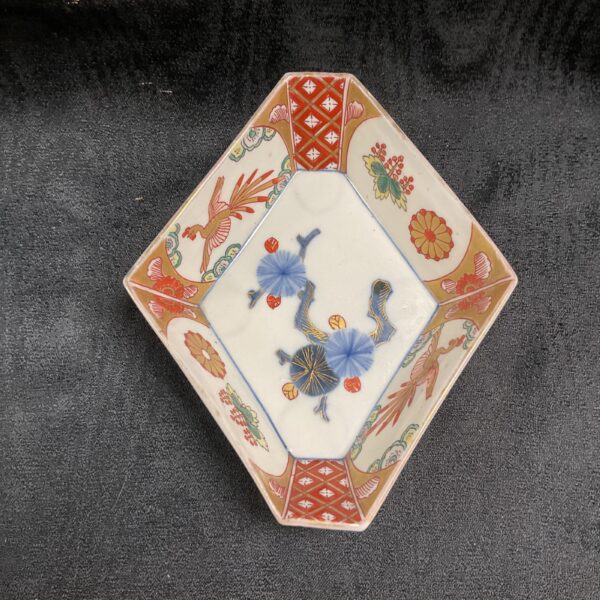 Antique Japanese Imari porcelain dish with hand-painted design.