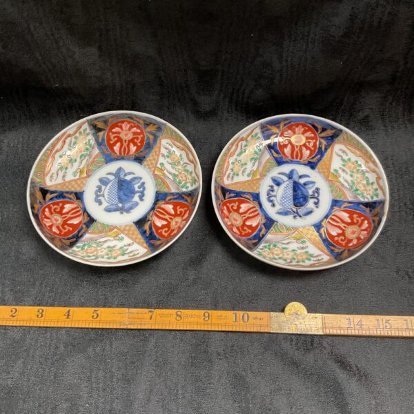 Pair of antique Japanese Imari dishes with vibrant decoration.
