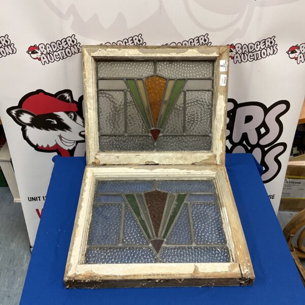 Antique leaded stained glass window with geometric design.