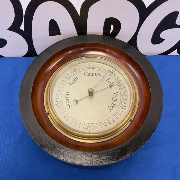 Antique mahogany barometer with Fahrenheit scale, a vintage weather instrument.