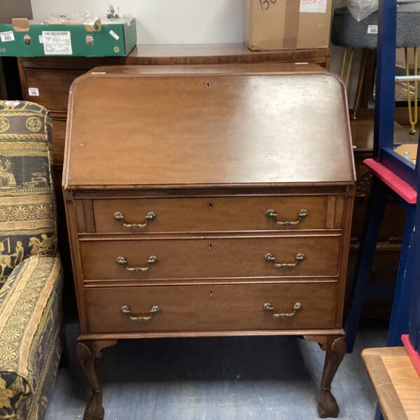 Antique mahogany writing bureau with drawers and sloping writing surface.