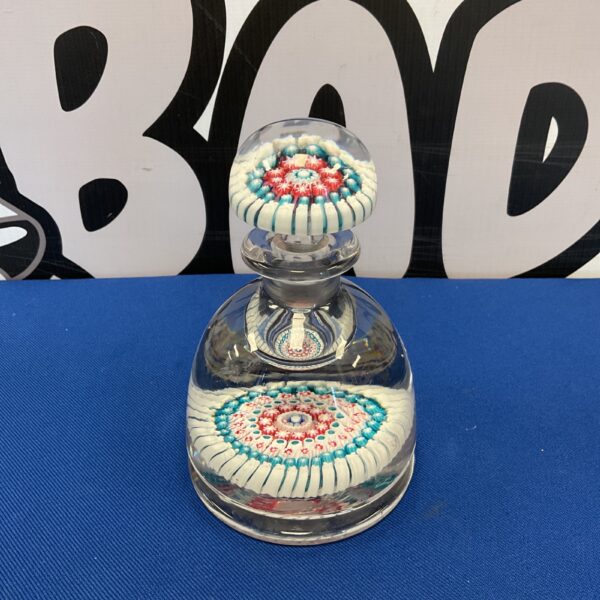 Antique millefiori inkwell with vibrant floral glass design.