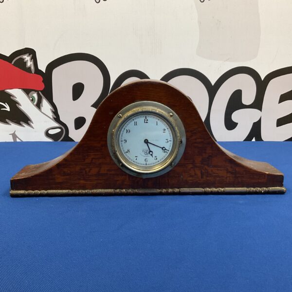 Antique Napoleon Hat Mantle Clock with white face and oak case.