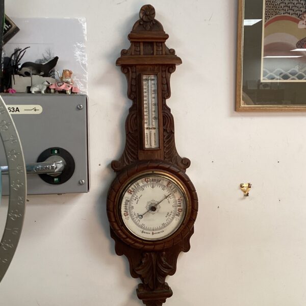 Antique oak cased aneroid barometer with silvered dial.