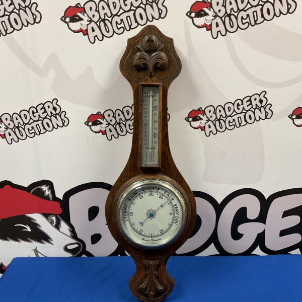 Antique oak cased aneroid barometer for measuring atmospheric pressure.