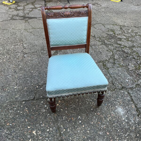 Antique oak bedroom chair with patterned upholstery.