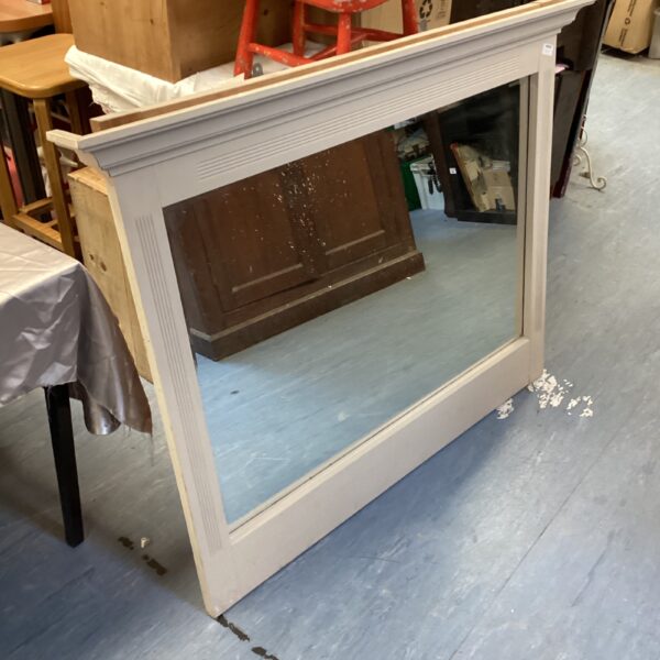 Large antique overmantle mirror with decorative frame.