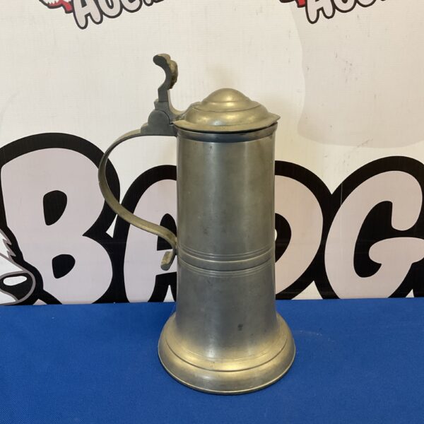 Antique pewter lidded tankard with rose pattern inside.