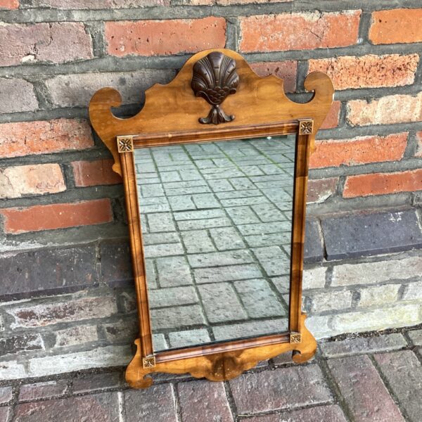 Antique reproduction wall mirror with yew wood carving.