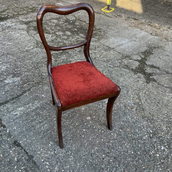Antique rosewood balloon back chair with curved splats.