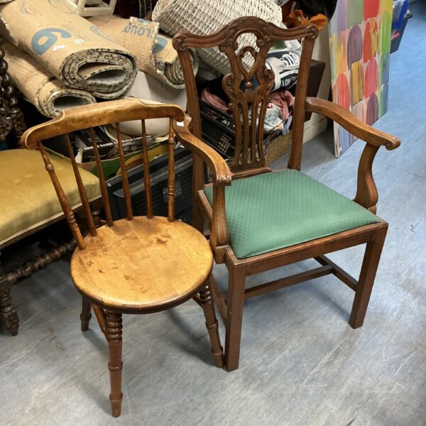 Pair of antique wooden chairs with round stick backs.