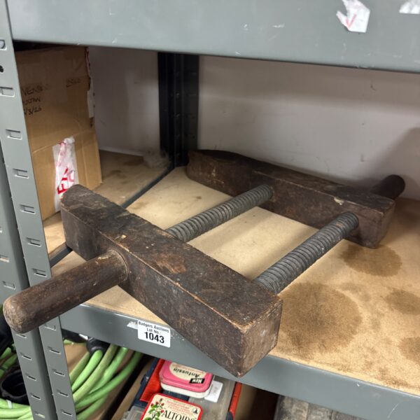 Antique woodworkers clamp with wooden handle and metal screw.