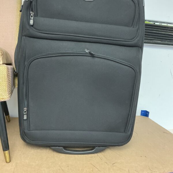 Front view of a vintage Antler suitcase with wheels.