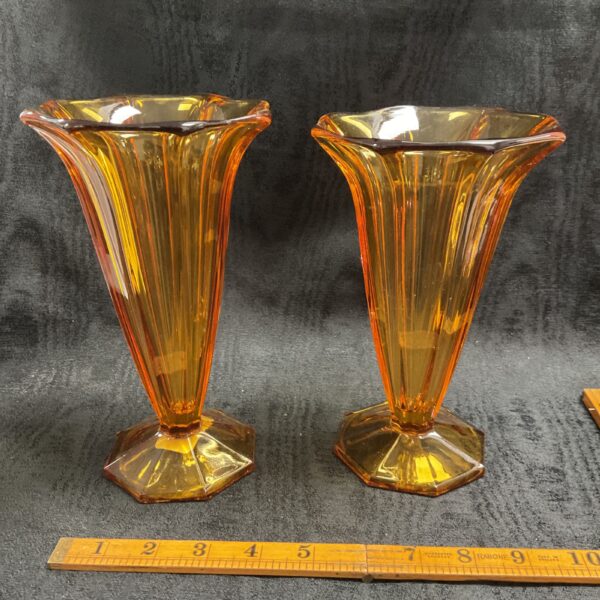 Pair of vintage Art Deco amber glass vases with geometric facets.