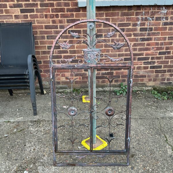 Vintage Art Nouveau window grille with hinged design for garden or home decor.